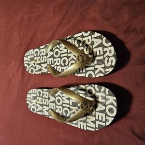 Michael Kors Gold Strap Logo Flip Flop Sandals on Black and White Logo Footbed